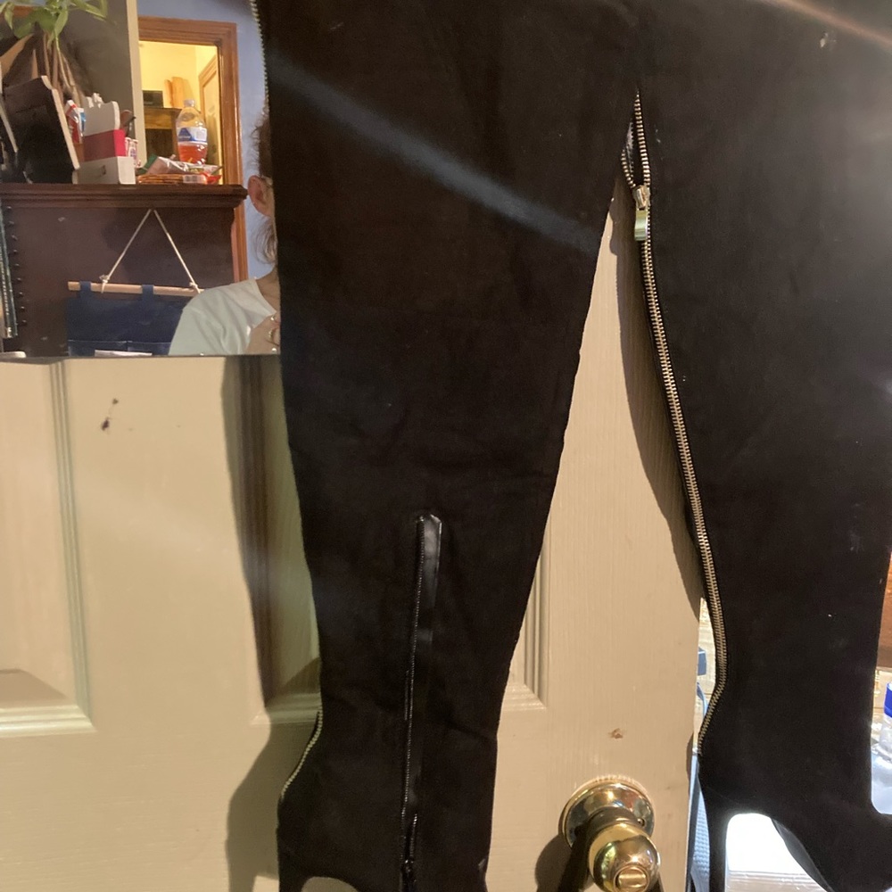 Black size 6 thigh high 4 in heel boots zip on inside and back of boot